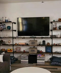 Heavy Duty Industrial Iron Pipe Shelf Brackets Set Two Pack Five Tier Open Bookshelf System in living room with decor