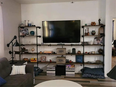 Heavy Duty Industrial Iron Pipe Shelf Brackets Set Two Pack Five Tier Open Bookshelf System in living room with decor