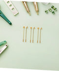Vintage Copper Flat Round Tray Lapel Pins With Strong Penetration And Wirewrapped Capability For Jewelry Making Crafts And Daily Wear Style Blanks laid out among crafting tools on a green background.