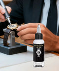 Pro Grade Clock Lubricant And Maintenance Grease For Grandfather Clocks And Watches, 50ml bottle next to a watch being repaired.