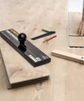 No Hammer Needed Tapping Block With Ergonomic Ball Handle for Installing Floors on wooden planks with tools nearby