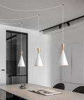 White Plug In Pendant Light Dope Cone Farmhouse Style for kitchen island with three hanging fixtures in modern room.