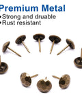 Pro Grade Bronze Upholstery Tacks And Decorative Furniture Nails For Wood Restoration rust resistant metal thumb pins arranged on white background.