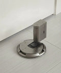 Solid Zinc Alloy Door Stopper With Suction Holder For Floor And Walls Holds Tight Against Wind To Keep Bedroom Office Quiet And Safe From Slams, installed on gray floor.