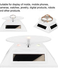 Xhtllo Electric Led Light Solar Powered Rotating Turntable Display Stand For Jewelry Phunique Watches Camera And Decorations with white base.