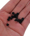 Hand holding black 3mm silicone hole plugs, 100Pcs Silicone Hole Plugs 3mm Round Button Caps With Heat Resistant And Dust Proof Protection Easy Install For Home And Industrial Control Panels Keeps Buttons Clean And Soft Touch Pro Grade.
