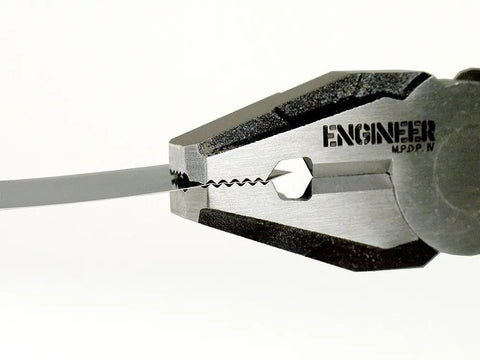 Close-up of a pair of Beefed Up Heavy Duty Multi Function Gripping Pliers And Screw Extractors For Damaged Screws With Non Slip Jaws cutting wire.