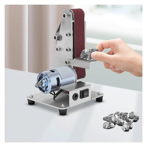 Mini Electric Belt Sander And Polisher Machine Desktop Grinding Tool with stainless housing and rock being sanded.
