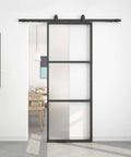 Frosted Glass Sliding Barn Door With Black Carbon Steel Frame 36In By 96In Soft Close Mechanism in modern living room.