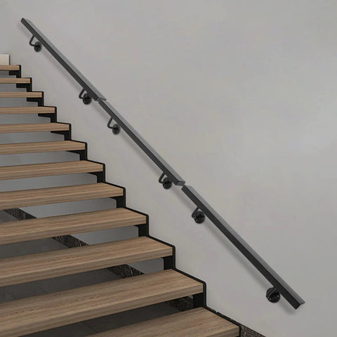 Tough Wall Mounted Stair Handrail Crafted From Heavy Duty Stainless Steel With A Sleek Black Baked Finish and solid support on wooden stairs.