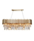 Straight Up Sleek K9 Crystal LED Pendant Light With Brushed Gold Metal Frame And Eight Warm E14 Bulb Slots over a dining table.