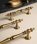 Vintage Cabinet Pulls 2 Pack Antique Brass Crown Shape Handles with 96mm hole spacing on light surface.