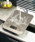 Ultra Accurate Kitchen Scale With 1g Precision For Cooking And Baking, Digital Food Scale in sink with water splash on stainless steel surface