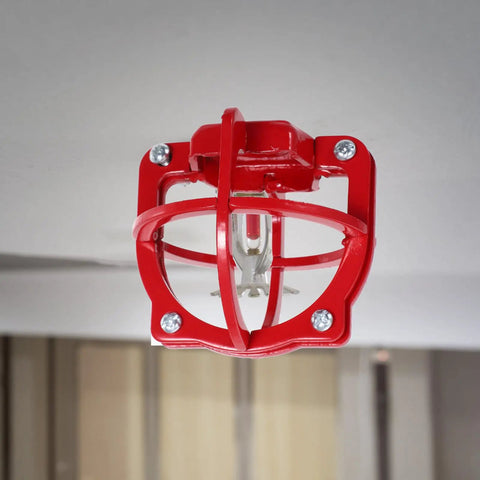 Bulldog Tough Fire Sprinkler Head Cage Guard and Protector for 1/2 Inch Iron Pipe in Bright Red Finish mounted on ceiling.