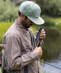 Man using Peak Series Personal Water Filter Straw for Backup Filtration and Emergency Survival Outdoors, Dark Mountain Gray.