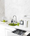Slick And Dead Simple Kitchen Drawer Organizer Tray With Stackable Compartments For Killer Silverware Sorting And No Sweat Flatware Storage Setup In Sleek Grey displayed in modern kitchen with utensils and grey drawer.