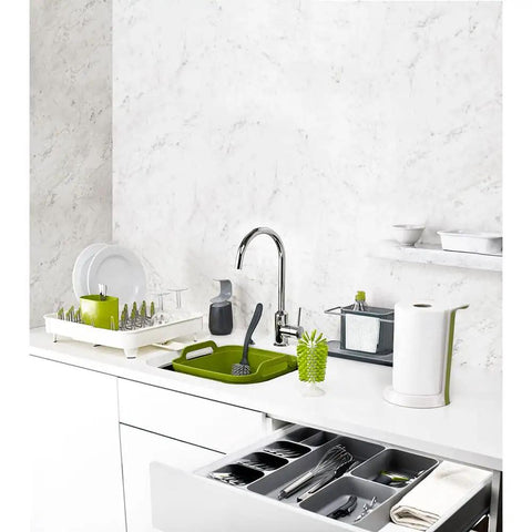 Slick And Dead Simple Kitchen Drawer Organizer Tray With Stackable Compartments For Killer Silverware Sorting And No Sweat Flatware Storage Setup In Sleek Grey displayed in modern kitchen with utensils and grey drawer.
