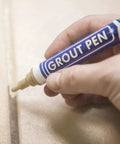Hand using Beige Tile Grout Pen For Waterproof Grout Paint And Sealer Colorant With Narrow 5mm Tip 7mL on tile surface