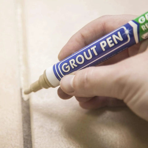 Hand using Beige Tile Grout Pen For Waterproof Grout Paint And Sealer Colorant With Narrow 5mm Tip 7mL on tile surface