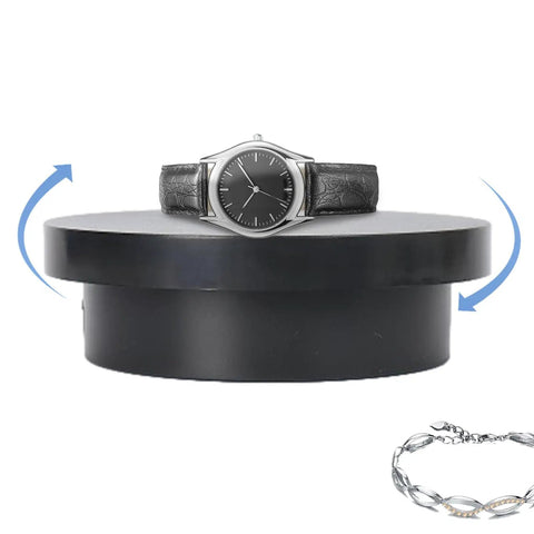 Cool Electric Turntable Display That Spins Your Goods 360 For Amazing Trade Fairs And Photo Shoots Plus It Runs On USB To Keep Things Easy And Green with a silver watch and bracelet on a black base.