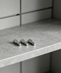Heavy Duty Iron Shelf Pegs 80 Piece Spoon Shaped 5mm Nickel Plated Cabinet Pins on marble countertop