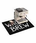 Spooktacular Black Witches Brew Coffee Station Mat Featuring Quick Dry Absorbent PU Material Designed For Kitchen Counter Espresso Machine Setup 28 By 18 Inch Halloween Spill Proof Drip Catch Pad with espresso machine and coffee cup.
