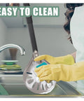Newmeto 7-inch round aluminum perforated pizza peel with metal handle being washed in kitchen sink.