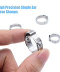 Stainless steel single-ear hose clamp, 7–21 mm, 4 pcs, held between fingers; background clamps visible