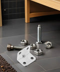 Close-up of 100 Pcs L Shaped Metal Corner Braces Cold Rolled Steel 90 Degree Right Angle Brackets on a floor