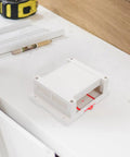 Flame Retardant ABS Junction Box for Wall Mounted Outlets and DIY Control Panels, indoor outdoor use, white plastic enclosure on table