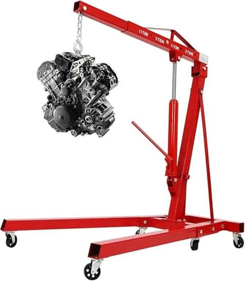 Shop Essential Two Ton Hydraulic Engine Hoist With Six Swivel Rollers And Quick Fold Frame lifting an engine block in a garage.