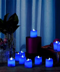 Blue White LED Flameless Candles With Realistic Flame Effect Battery Powered Votive Lights displayed in a dark room setting