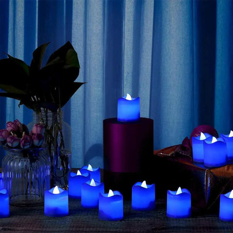 Blue White LED Flameless Candles With Realistic Flame Effect Battery Powered Votive Lights displayed in a dark room setting