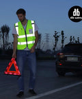 High Visibility Reflective Safety Vest For Men And Women With Pockets And Zipper ANSI Class 2 Yellow XL worn by man at roadside