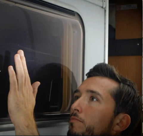 Person inspecting acrylic scratch remover for clear plastic and plexiglas on caravans that removes scratches fast with pro grade results.
