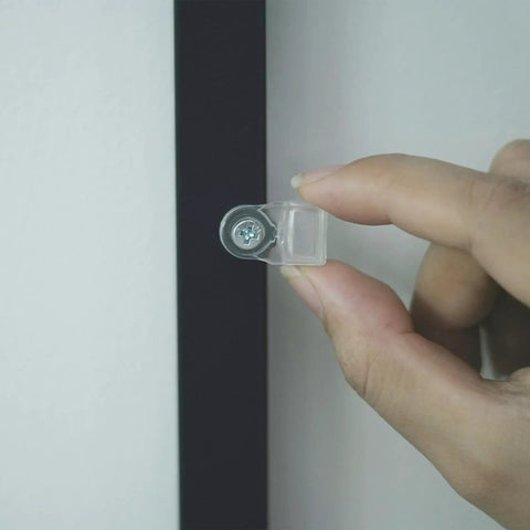 Real Deal 25 Pack Glass Retainer Clips With Screws For Cabinets Windows Doors And Mirrors Universal Clear Transparent Panel Hardware All Weather Zero Drama Install, close-up of a clear clip being held.