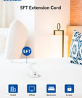 Six In One Power Strip With Surge Protection Three AC Outlets Two USB C Ports 65W Fast Charging And One USB A 18W MacBook Compatible Five Foot Extension Cord Ideal Home Office Charging Station shown on hotel bed with 5FT label, lamp and pillow in background.