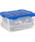 60-Quart Clear Airtight Storage Totes with Secure Latching Lid Stackable Plastic Containers for Garage Basement Closet That Are Built Different and Handle the Heat like Pros with folded blankets inside.