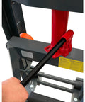 Close-up of a hand operating the handle on Beast Of A Heavy Duty Hydraulic Machinery And Equipment Mover With Adjustable Forks Swivel PU Wheels.