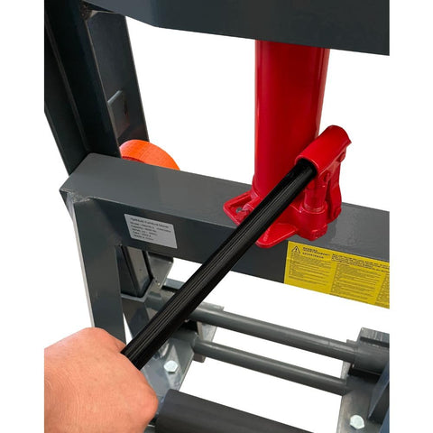 Close-up of a hand operating the handle on Beast Of A Heavy Duty Hydraulic Machinery And Equipment Mover With Adjustable Forks Swivel PU Wheels.