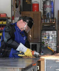 Person using angle grinder wearing Premium Grain Elkskin Stick Glove With Nomex Lined Back, Thumb Strap, Extra Thick, Kevlar Stitching