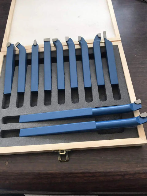 Top Shelf 11 Piece Tungsten Carbide Lathe Turning Tool Set With Heavy Duty Boring Bars And Roughing Grooving Inserts Built Tough, displayed in a wooden case.