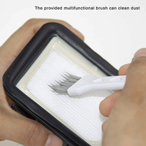Hands using a brush on a vacuum filter, part of the Multi Surface Pet Brush Rolls And Vacuum Filters Replacement Parts set