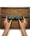 Hands using Never Measure Picture Hanging Kit 2 Size Bundle for easy picture frames and collages, precise alignment tool.