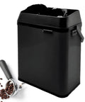 Game Changer Electric Espresso Knock Box And Automatic Portafilter Cleaner, black, with coffee handle and beans beside it.