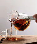 Clear Glass Turkish Coffee Pot 450ml Teapot For Hot And Cold Drinks With Retro Design pouring into a glass cup