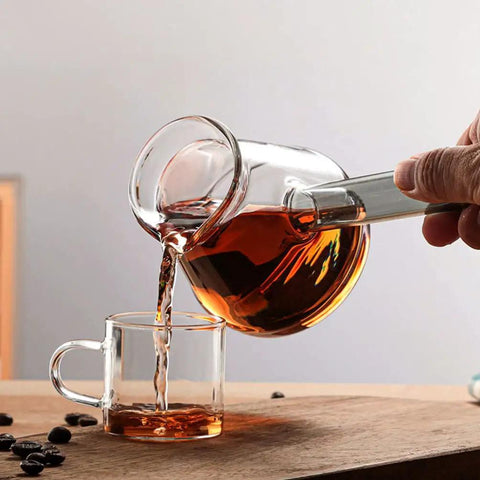 Clear Glass Turkish Coffee Pot 450ml Teapot For Hot And Cold Drinks With Retro Design pouring into a glass cup