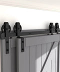 Hard Wearing Sliding Barn Door Track Hardware Kit For Tight Spaces Black Powder Coated 6mm Carbon Steel With Ultra Quiet Rollers And Bypass Option, Library Ladder Style, Fits Single Or Double Wooden Doors In Low Ceiling Areas installed on a grey door.