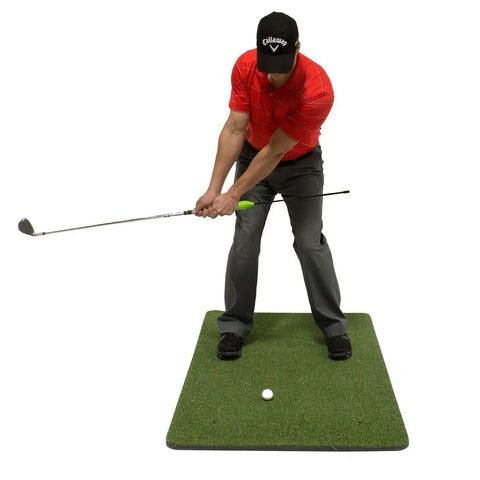 Golfer using Chip Stix Golf Swing Trainer Aid Chip N Pitch Mastery Black And Green Improve Short Game With More Spin tool on mat