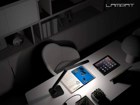 Super Handy Dimmable Led Desk Lamp with Four Lighting Modes in piano black illuminating a desk with tablet and book